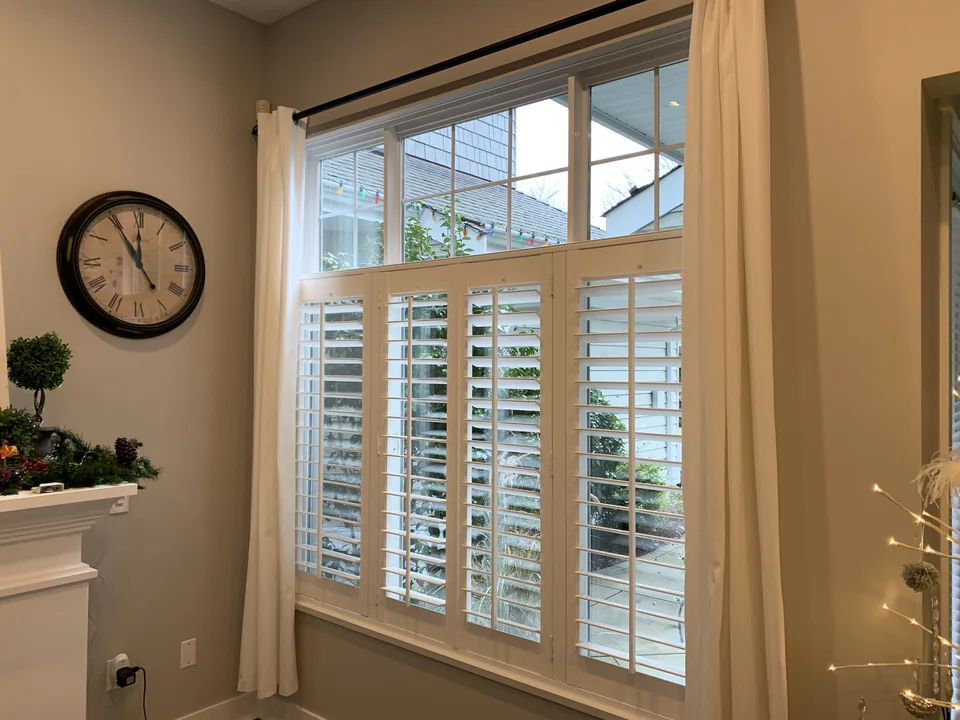 Shutter panels cover the lower opening while the upper transom remains clear