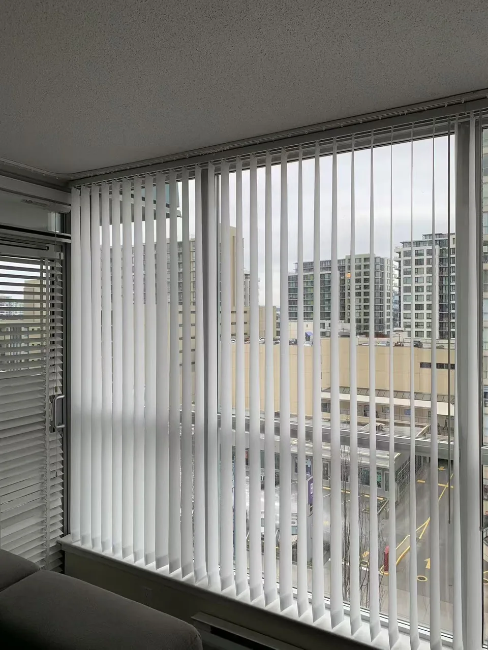 White vertical slats run across a glazed balcony opening